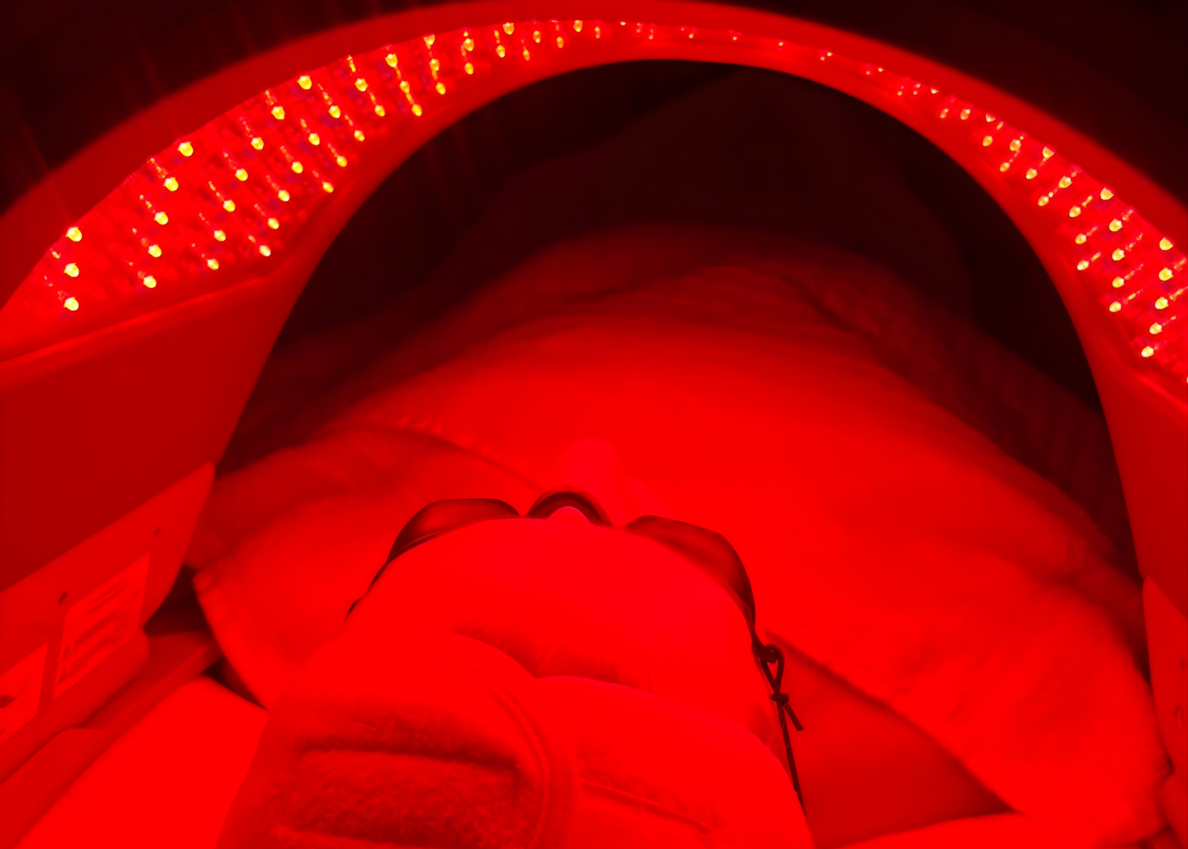 Red light therapy device with 'Dermalux' branding.