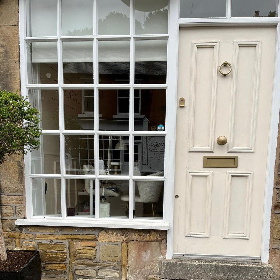 White door with glass panels on a stone building